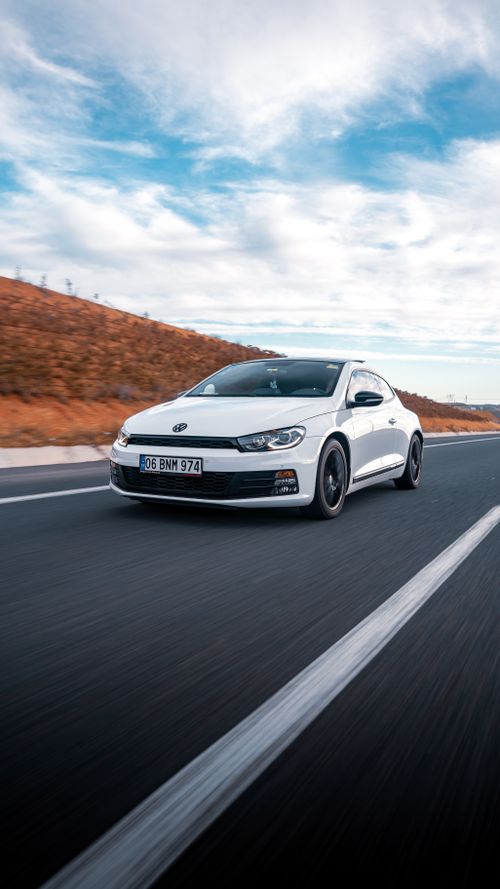 Free White Volkswagen driving on a highway in Ankara, Türkiye, showcasing speed and modern design. Stock Photo