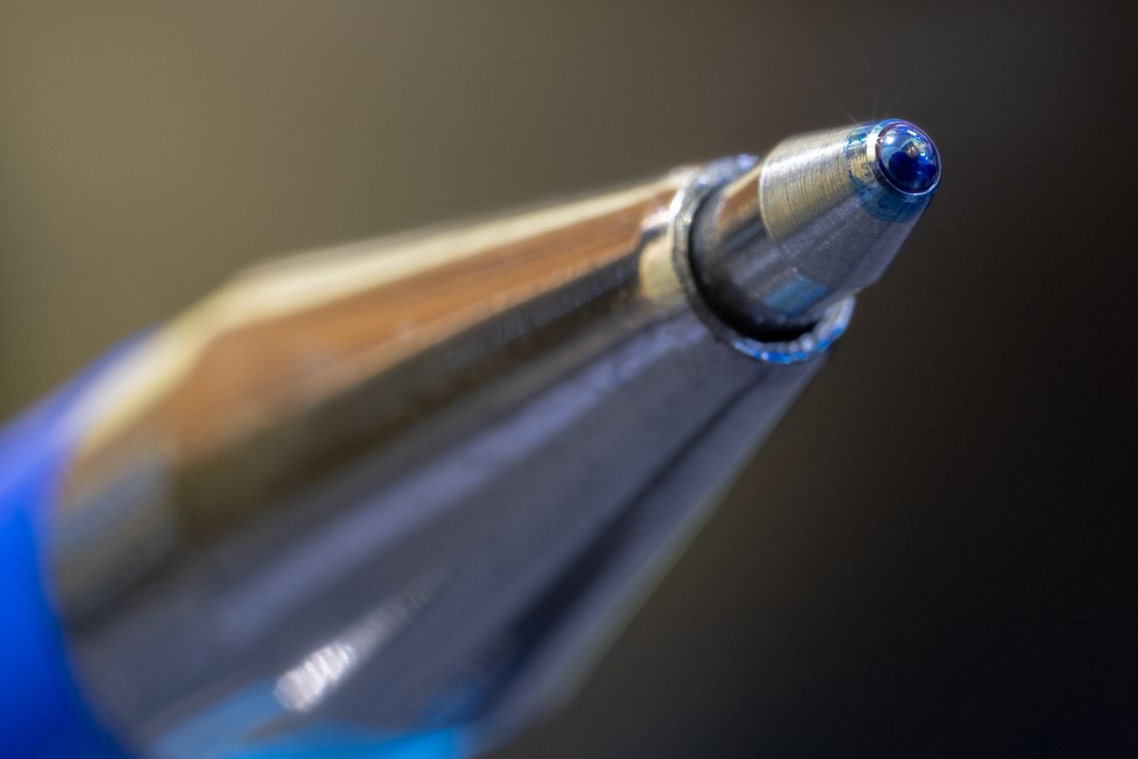 A fountain pen resting on a stand showing its balance profile — pen weight and balance