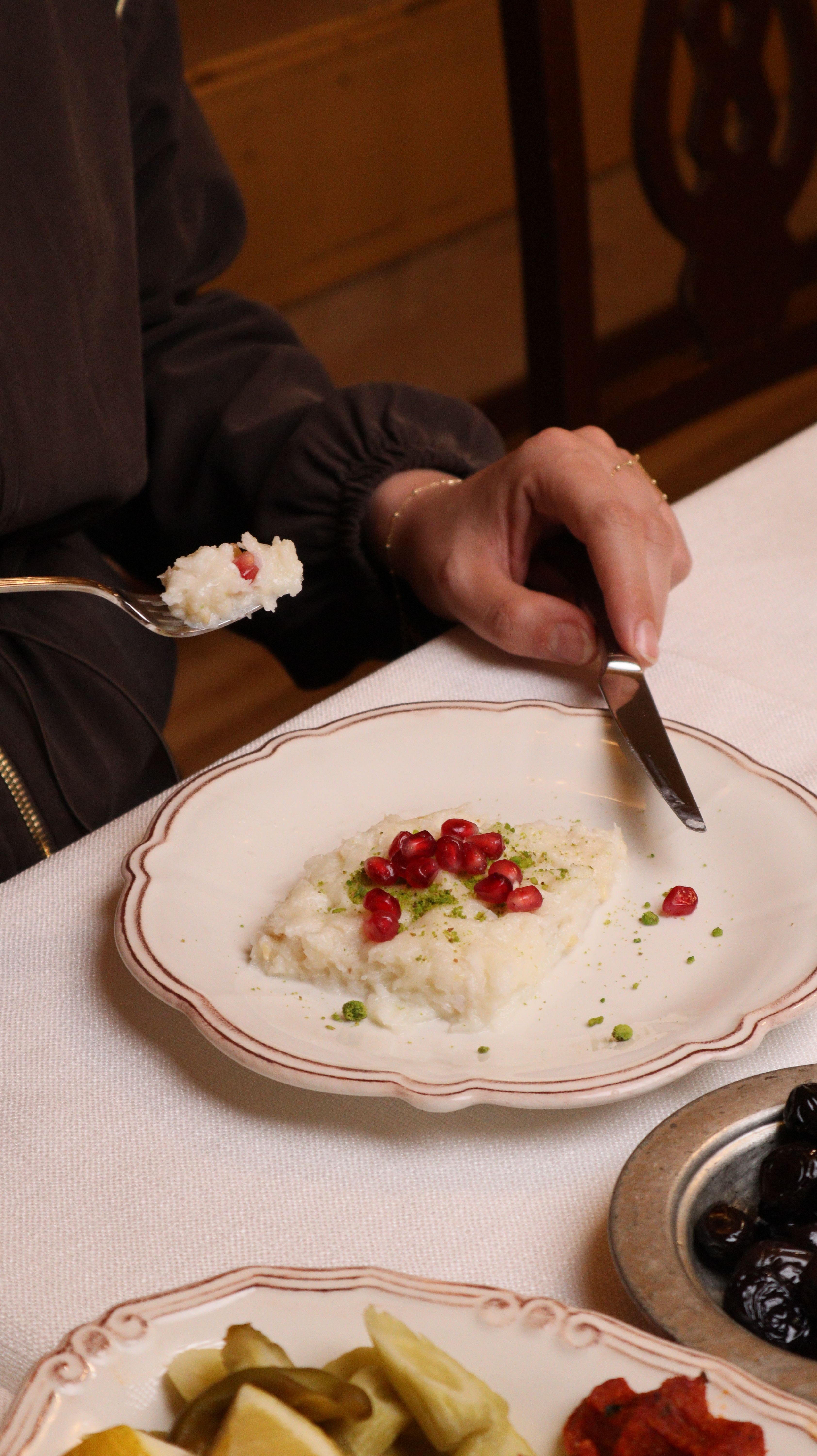 A dish of traditional Turkish dessert garnished with pomegranate and pistachios, in Gaziantep.
