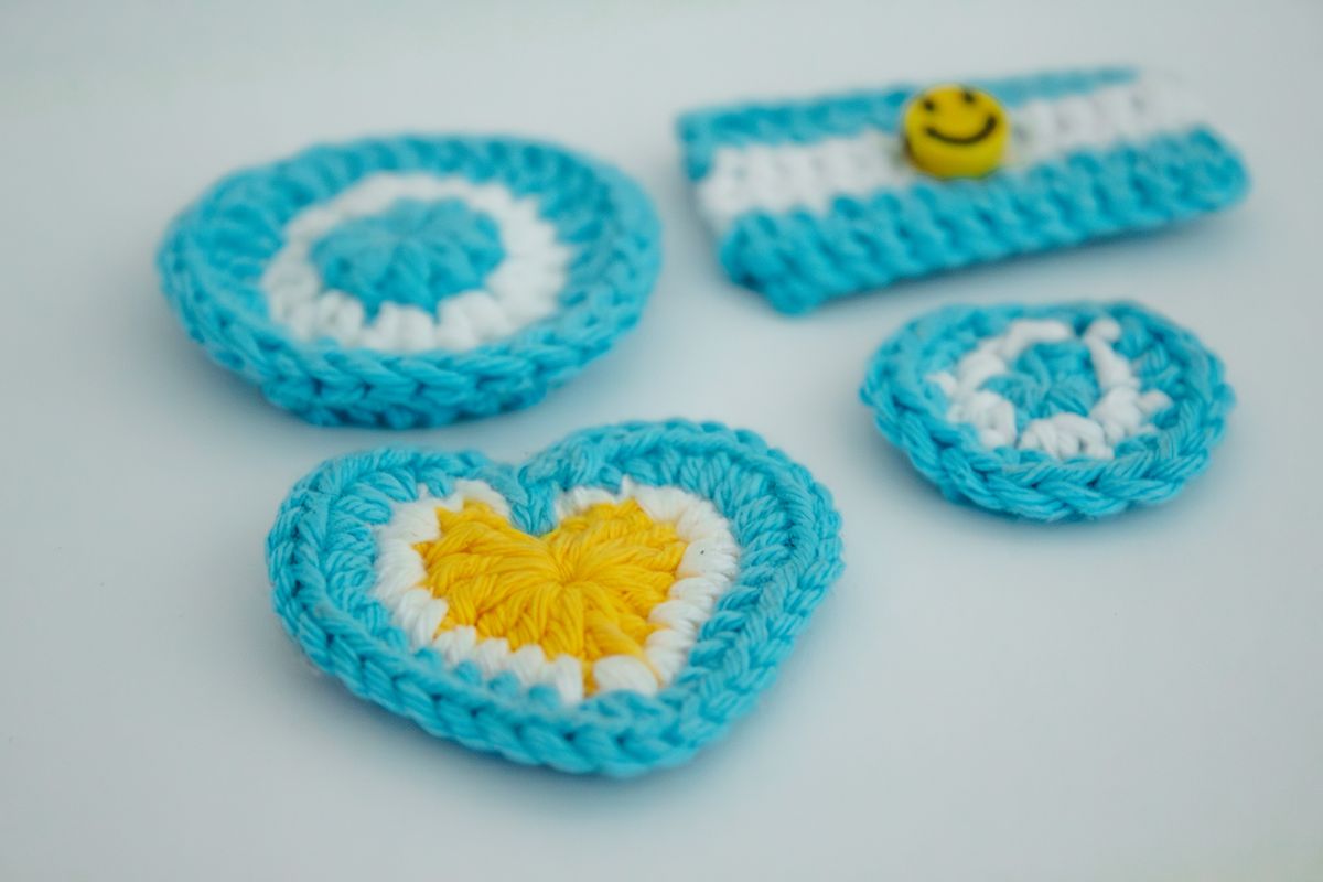 Colorful crocheted items with a yellow heart detail