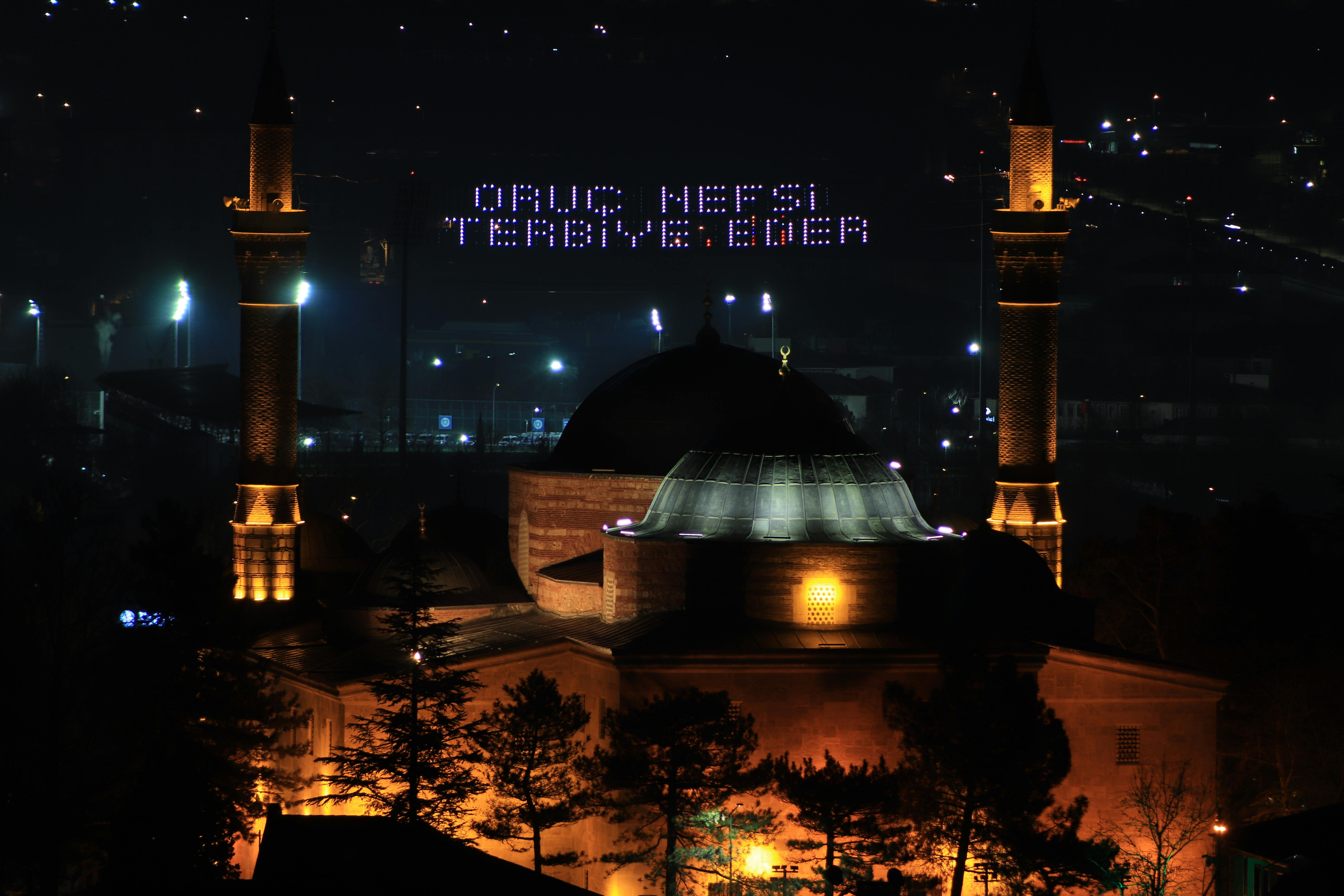 Illuminated Grand Mosque in Bursa, Türkiye, showcasing traditional Ottoman architecture at night.