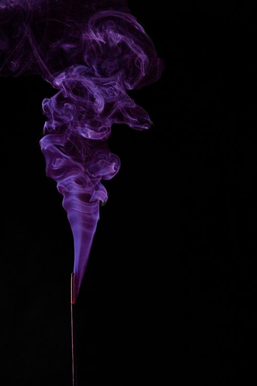 Free Artistic capture of swirling purple incense smoke creating abstract patterns against a dark backdrop. Stock Photo