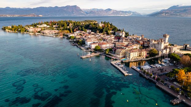 Captivating aerial view of Sirmione peninsula in Lake Garda, Italy, showcasing historic architecture and serene waters.