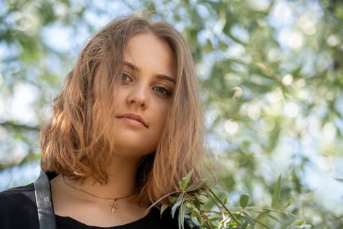 Free Portrait of a young woman enjoying summer in a Helsinki park. Stock Photo