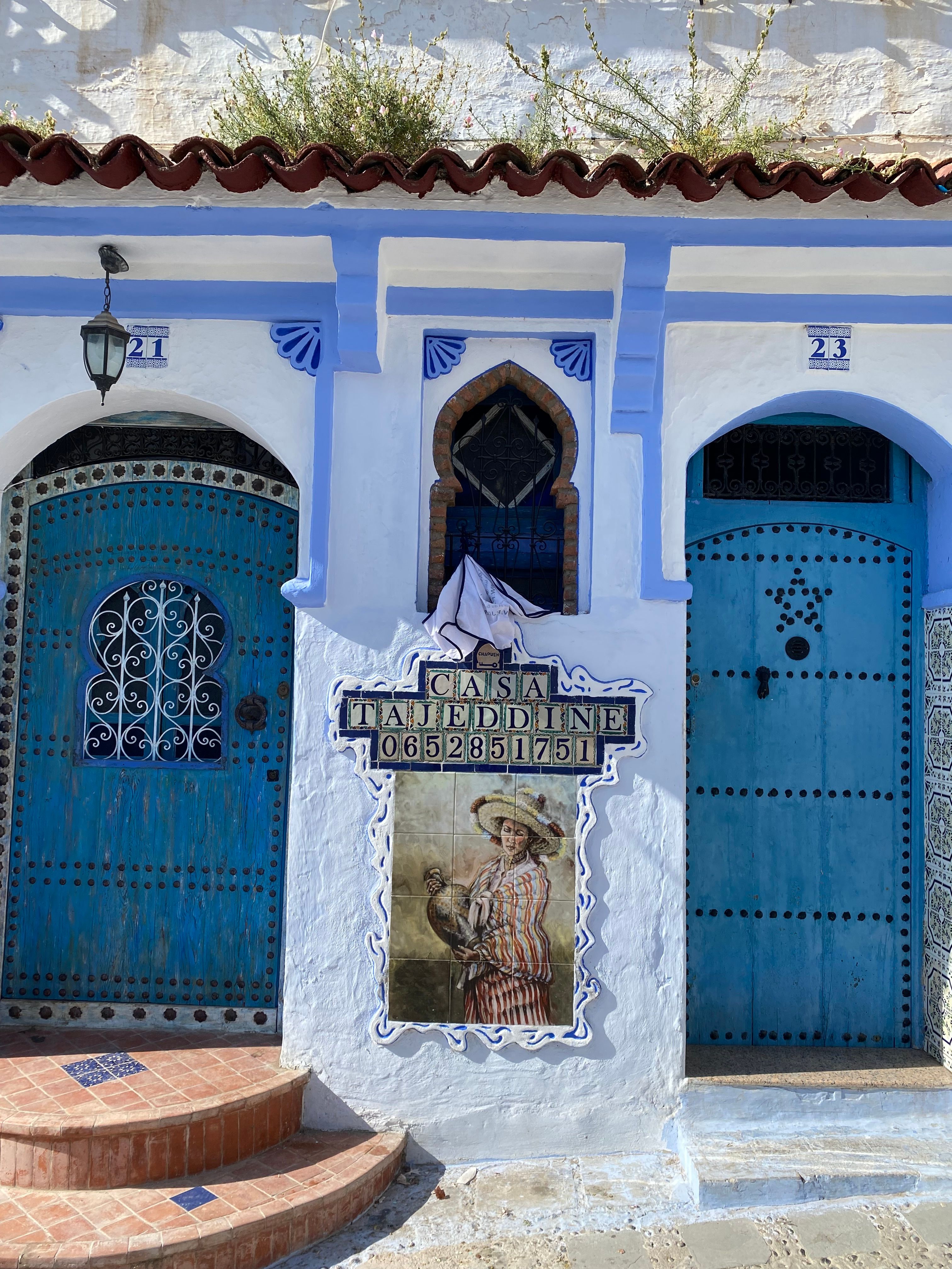 Colorful blue doors adorn traditional Moroccan architecture in Chefchaouen.