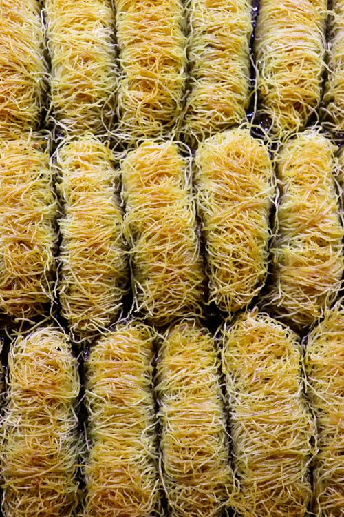 Free Close-up of golden brown Turkish desserts arranged in rows, showcasing texture and freshness. Stock Photo