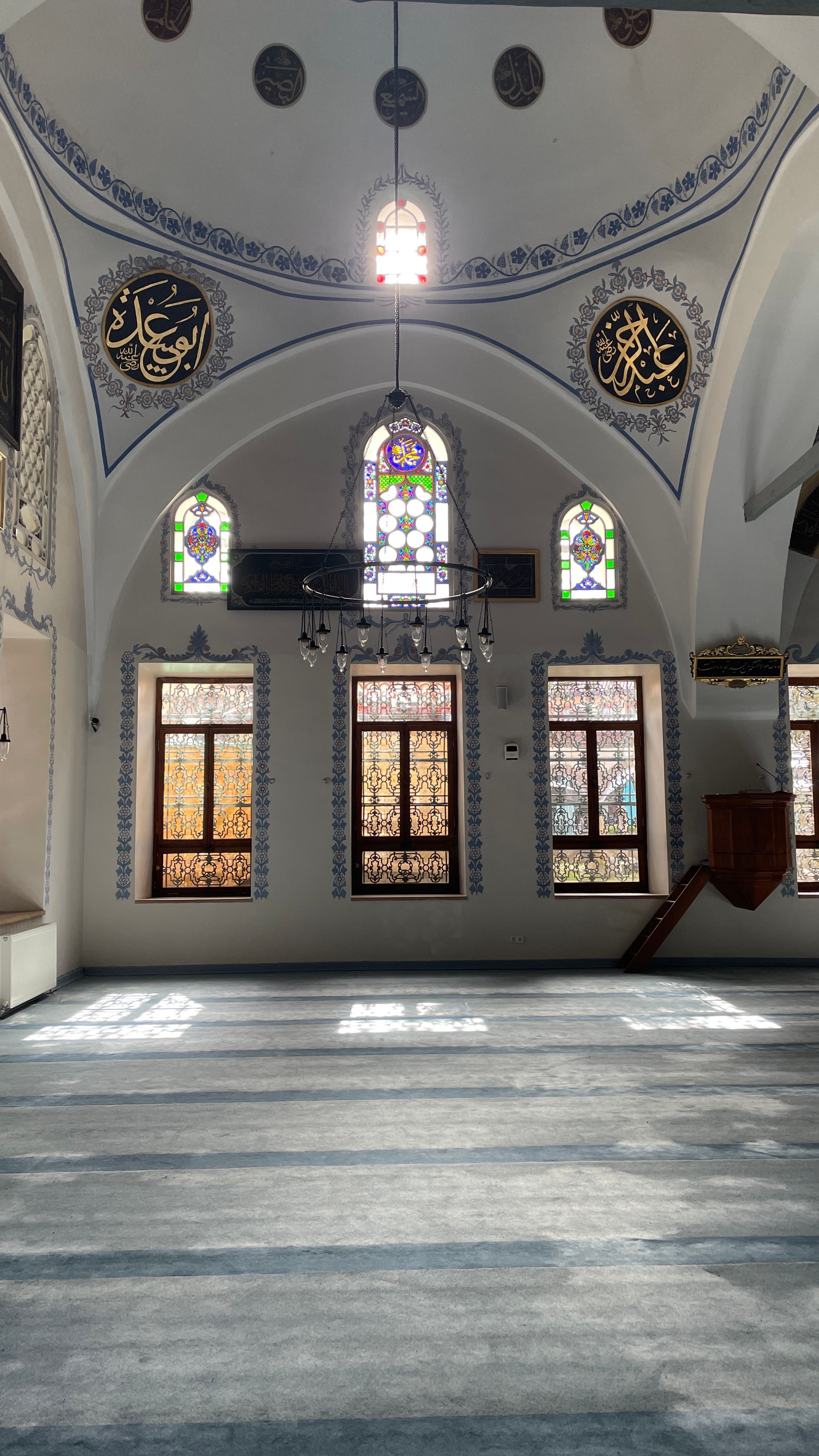 Stunning interior view of a historic mosque in Kastamonu, Turkey with beautiful stained glass windows and intricate designs.