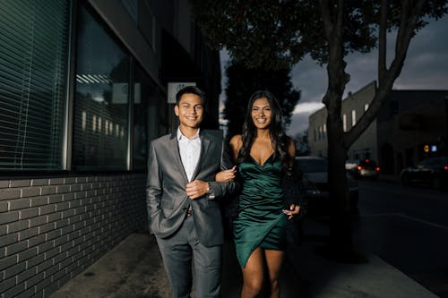 Free Man in Gray Suit Standing Beside Woman in Green Dress Stock Photo