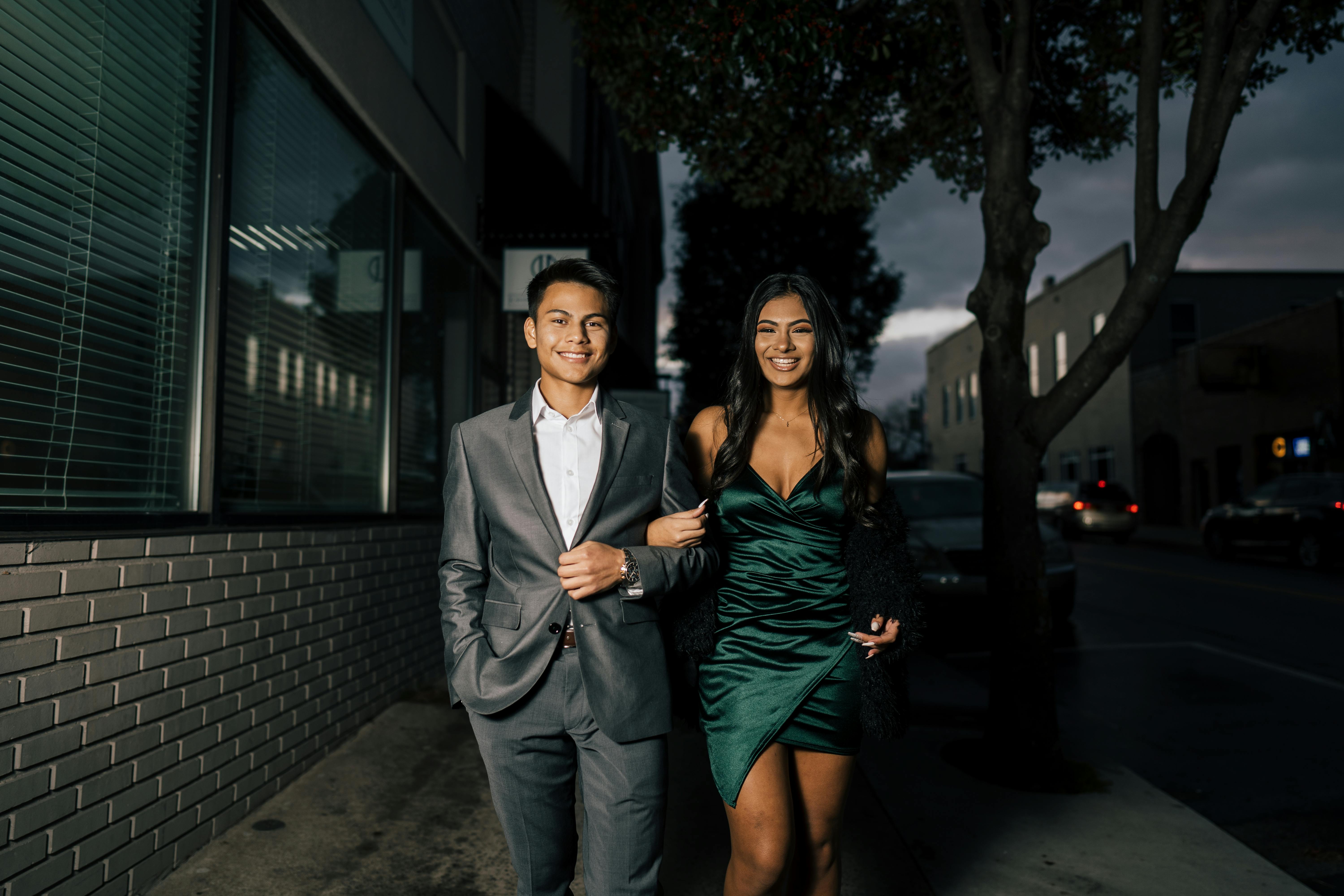 Man in Gray Suit Standing Beside Woman in Green Dress · Free Stock Photo