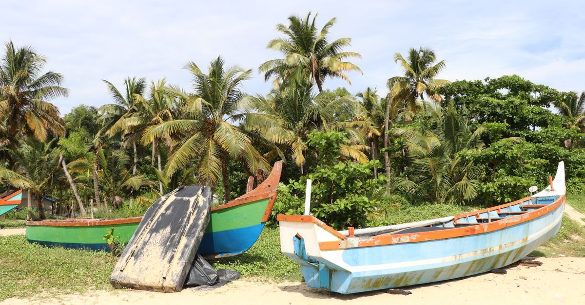 Uppuveli Beach in Trincomalee with traditional fishing boats and beachfront hotels