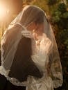 Romantic Wedding Kiss Under Delicate Veil