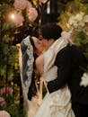 Romantic Wedding Kiss in Lush Garden Setting