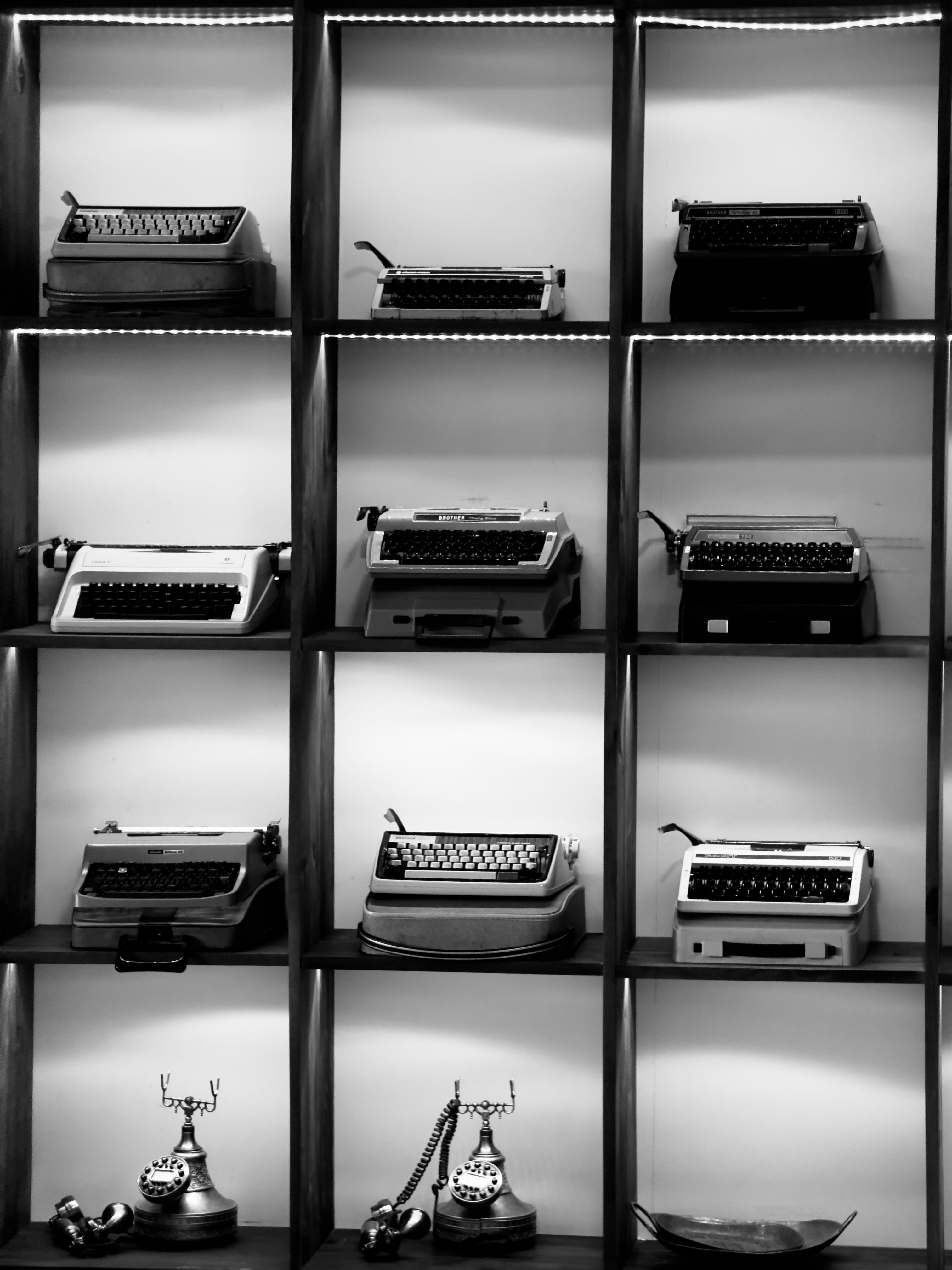 Vintage Typewriters and Telephones Display · Free Stock Photo