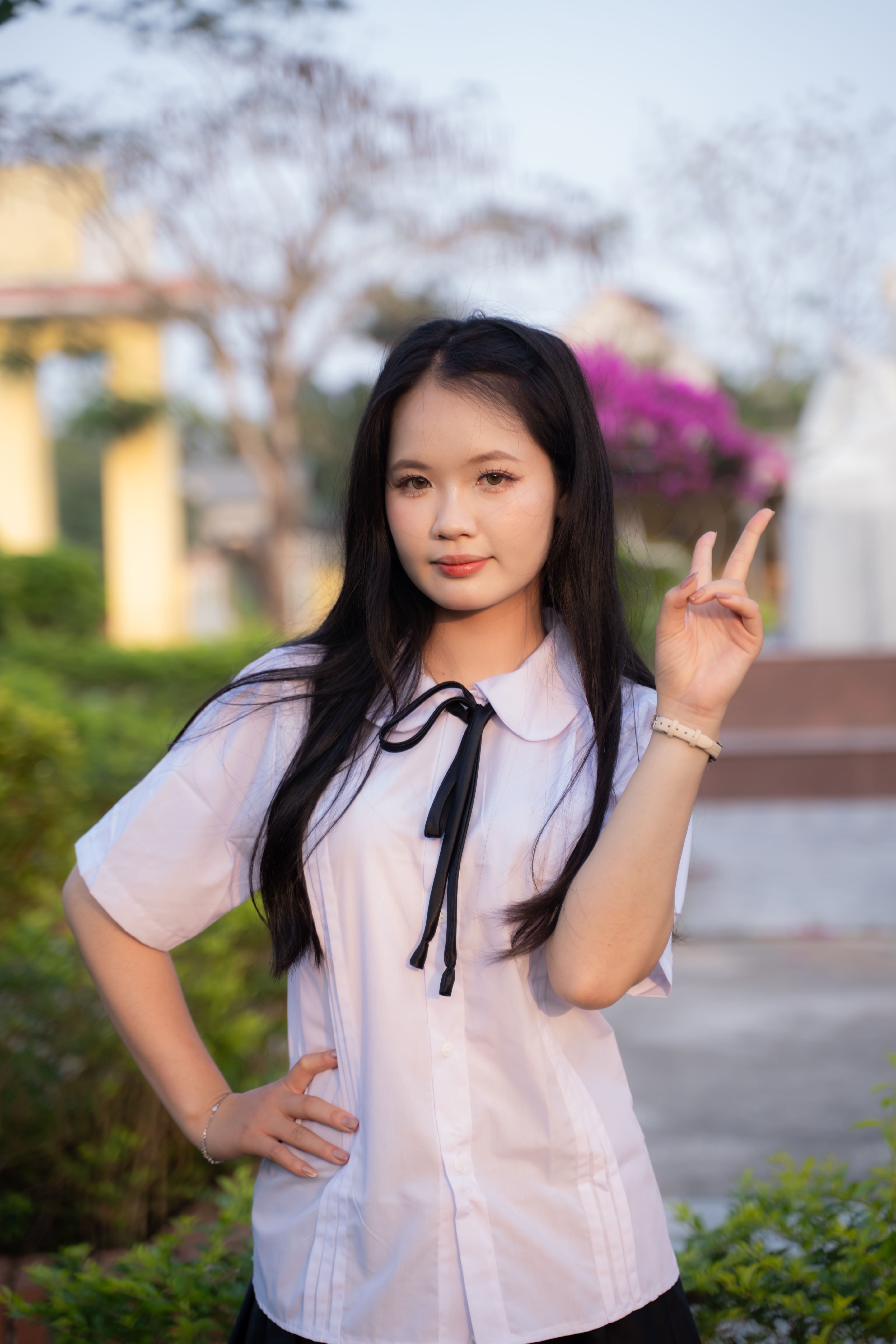 Young Woman Posing Outdoors with Peace Sign · Free Stock Photo