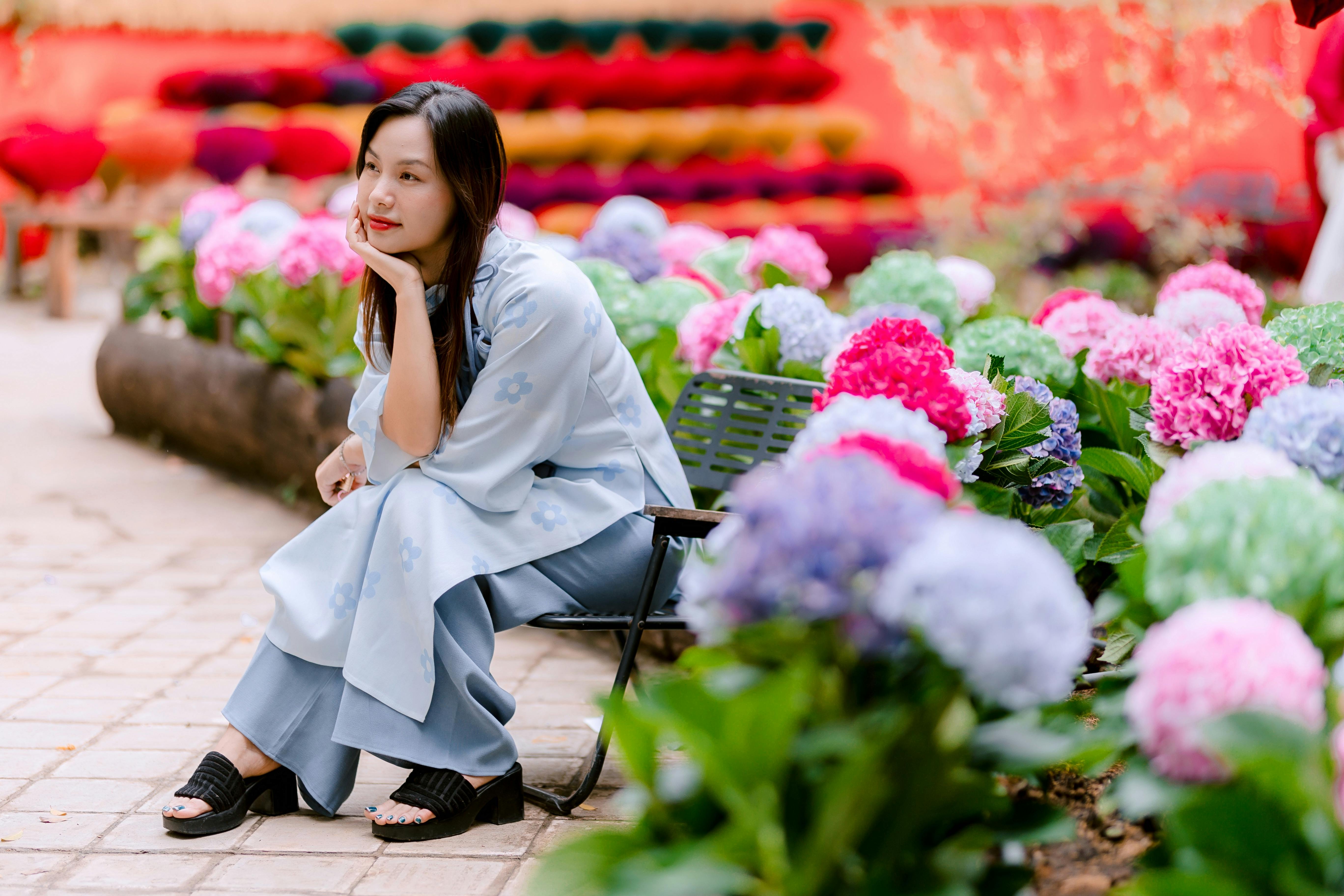 Woman in Garden with Colorful Hydrangeas