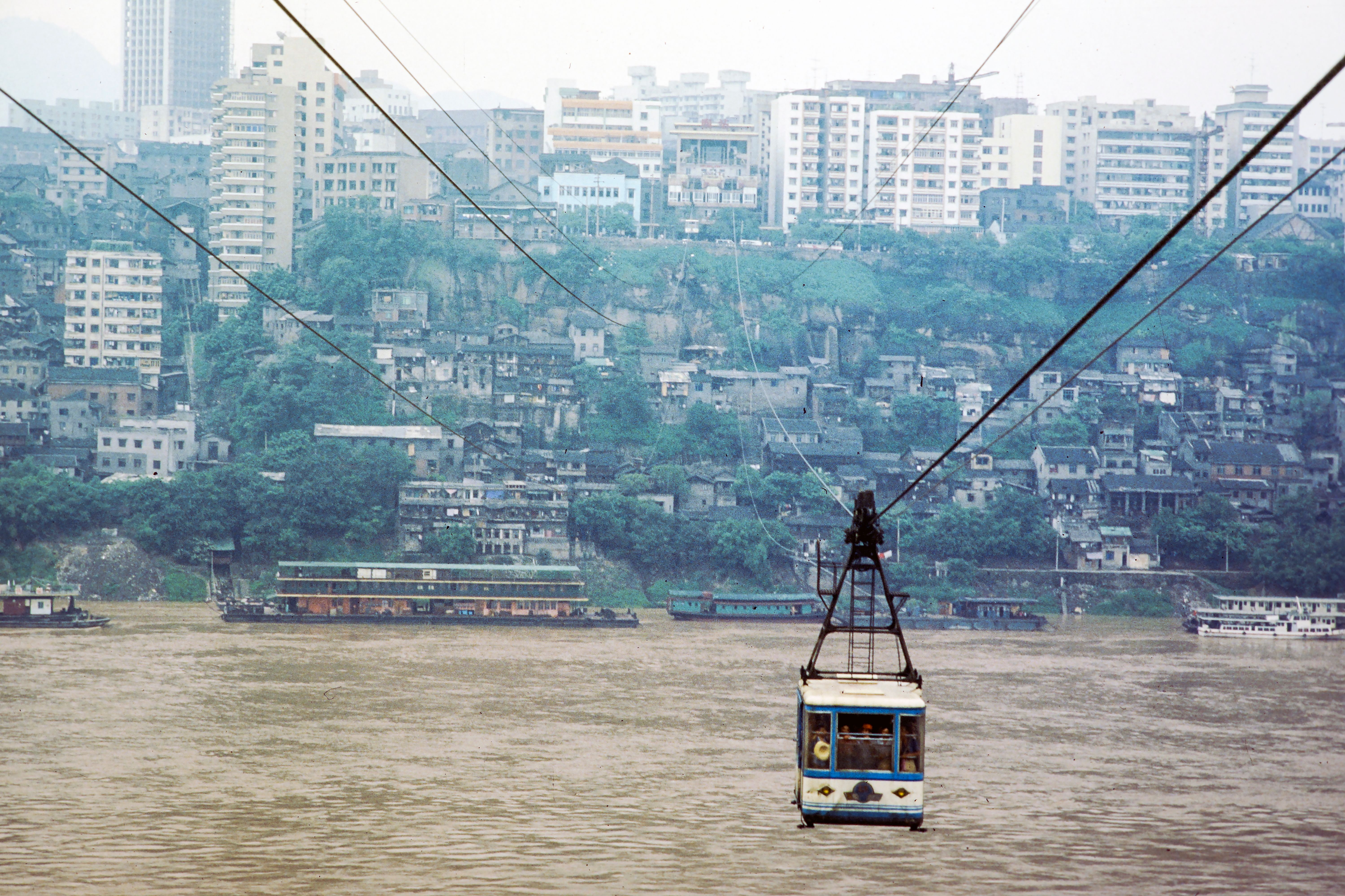Cable car aerial tramway crossing wide river city