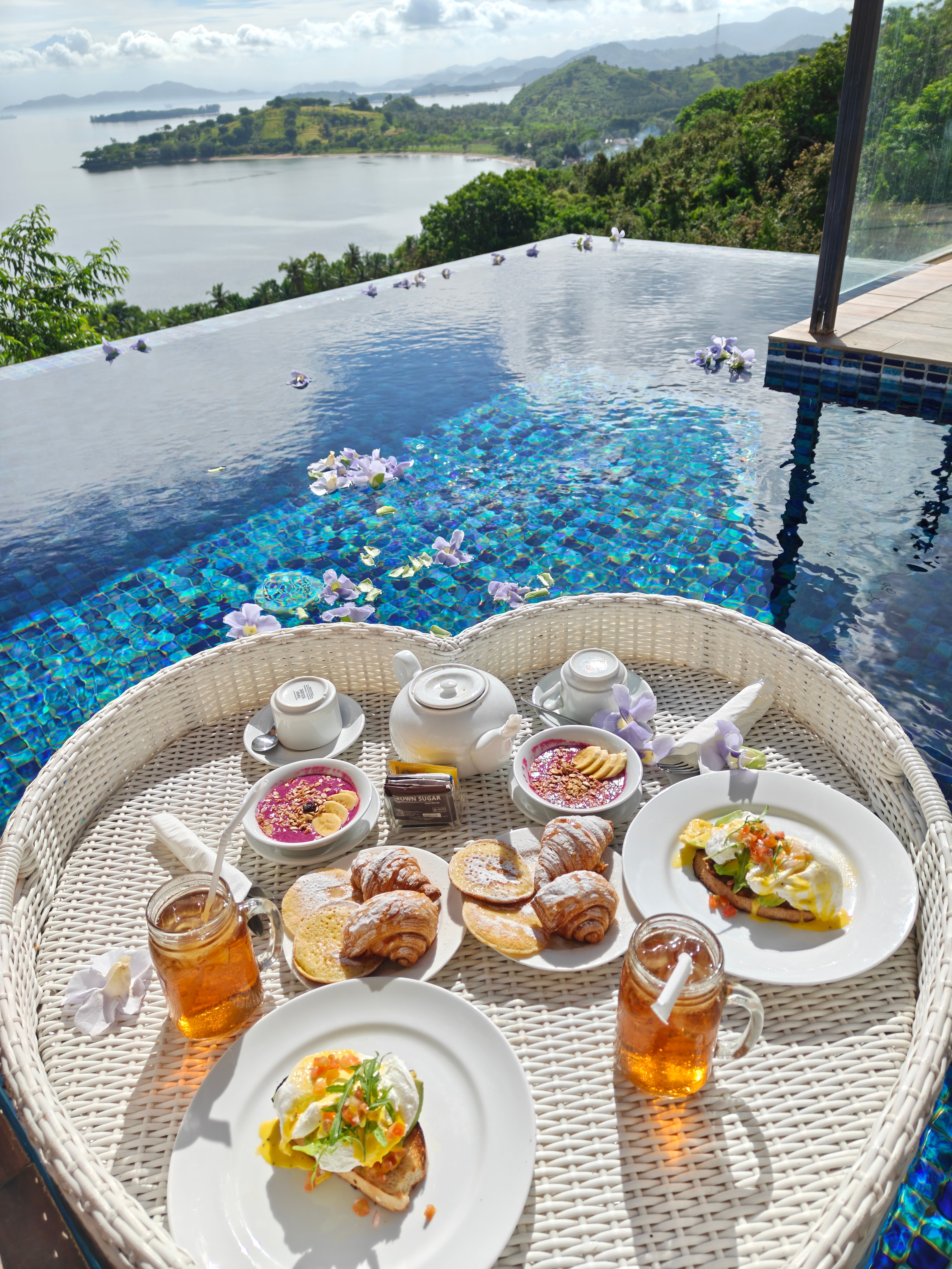 Floating breakfast tray of fruit and pastries on a private plunge pool at a luxury Bali resort villa