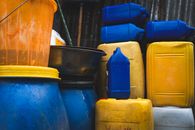 Vibrant assortment of yellow, blue, and orange plastic containers stacked outdoors in Ethiopia.