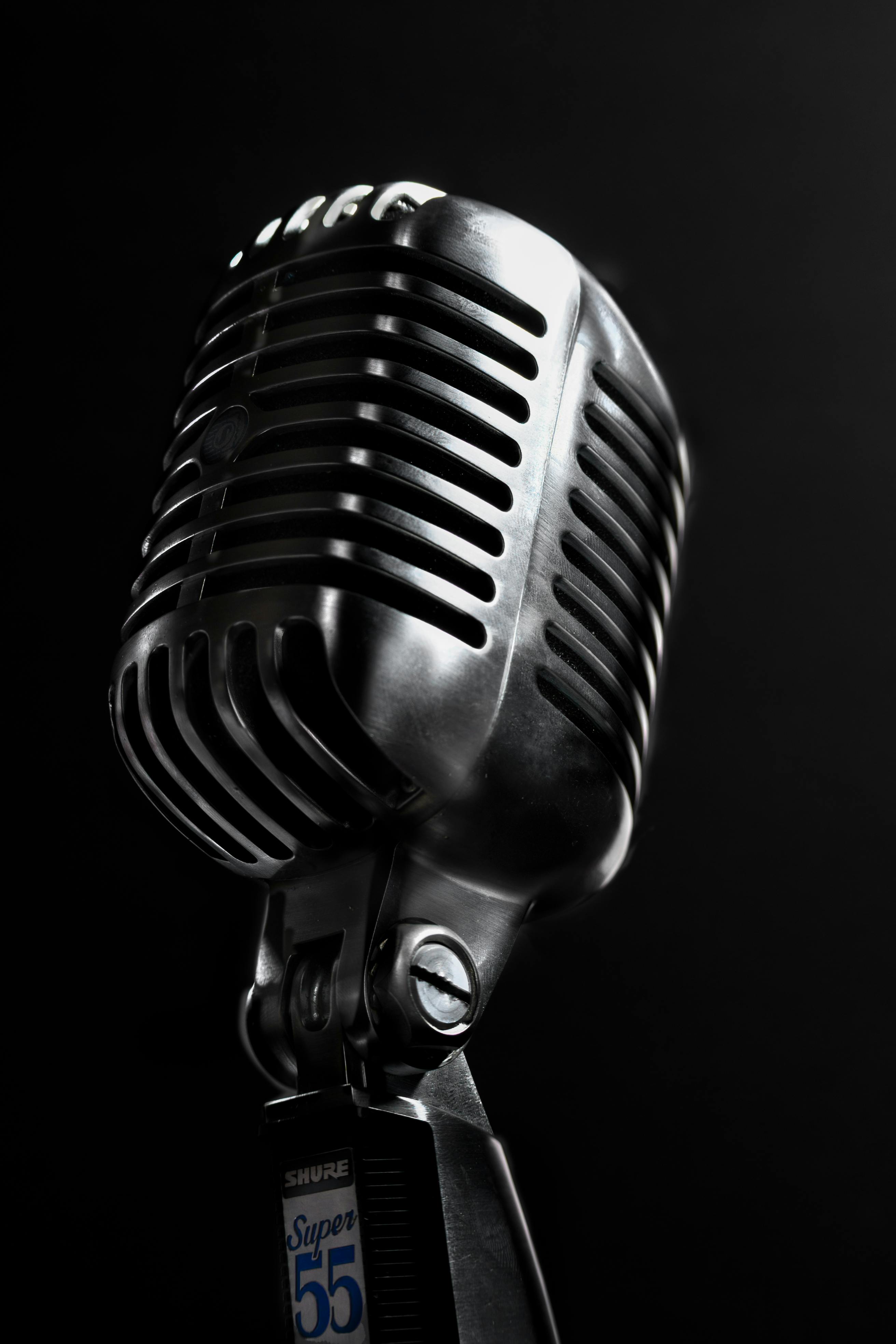 Classic chrome microphone against a dark backdrop, emphasizing its retro design.