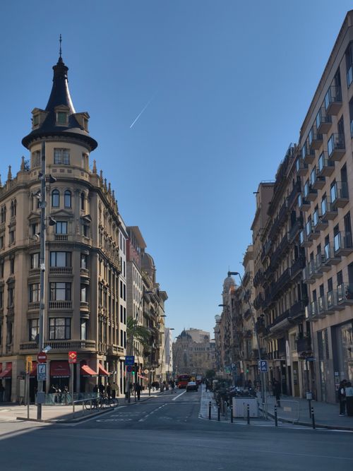 Free Beautiful European city street with historic architecture under clear blue skies. Stock Photo