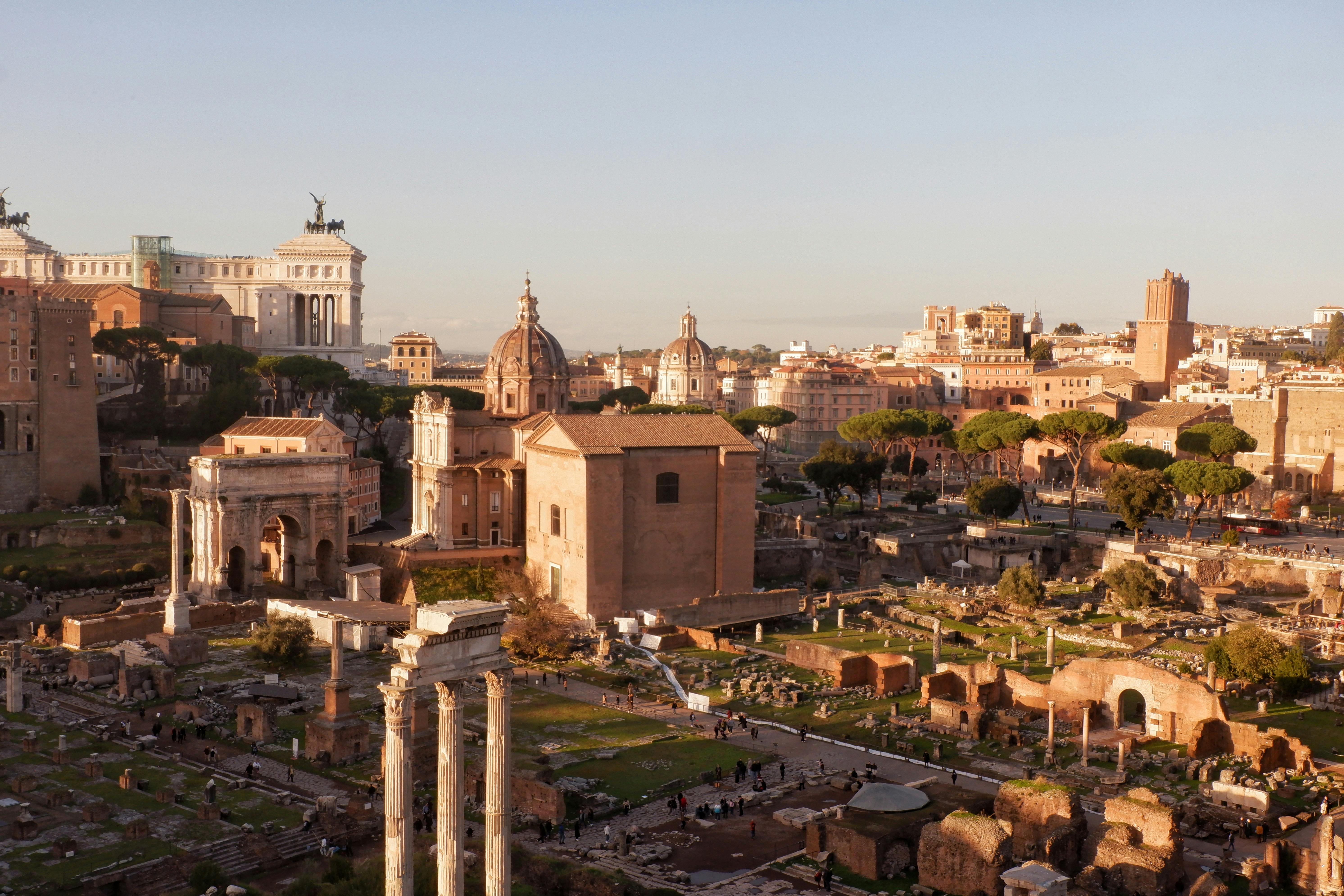 Explore the ancient ruins of the Roman Forum in Rome, Italy, captured at sunset with stunning architectural details.