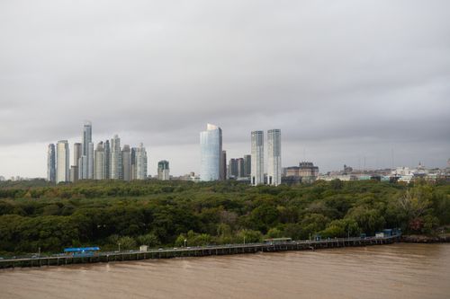 Free Aerial view of Buenos Aires skyline with skyscrapers and lush green forest. Stock Photo