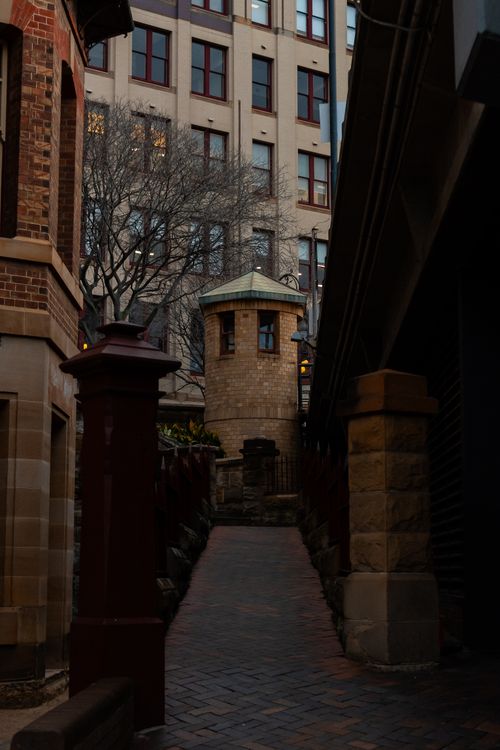 Free A narrow Sydney alleyway framed by historic architecture during twilight. Stock Photo
