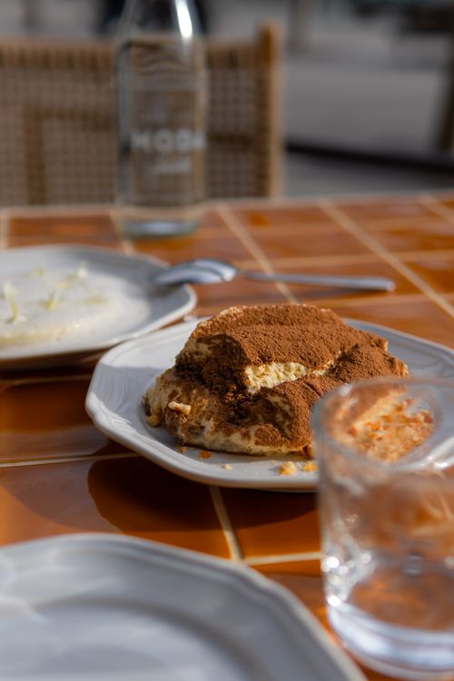 Free Delicious tiramisu dessert served on a sunlit outdoor cafe table in Sydney, Australia. Stock Photo