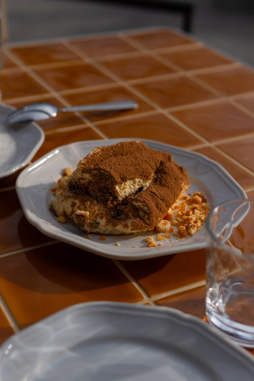 Free Close-up of a tiramisu dessert on a sunny outdoor table, Sydney. Stock Photo