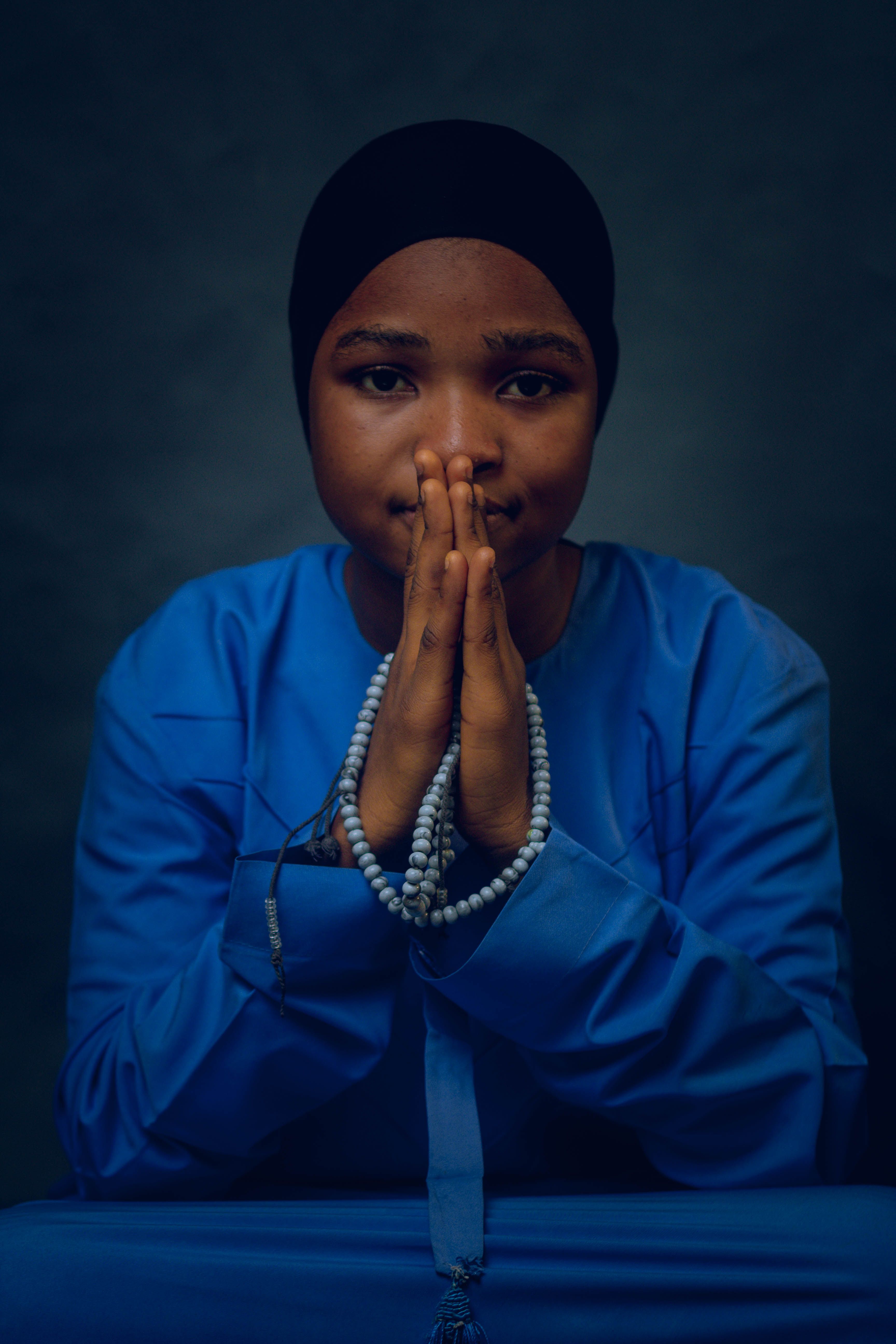 Person in Traditional Attire Holding Prayer Beads · Free Stock Photo