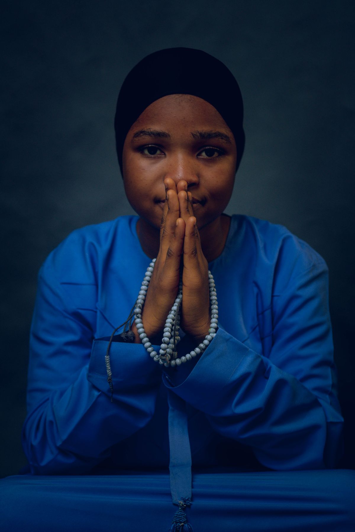 Person in Traditional Attire Holding Prayer Beads · Free Stock Photo