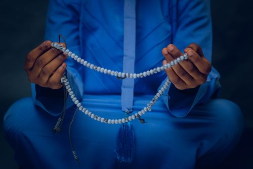 Free A close-up of hands holding prayer beads, focusing on spiritual and cultural themes. Stock Photo