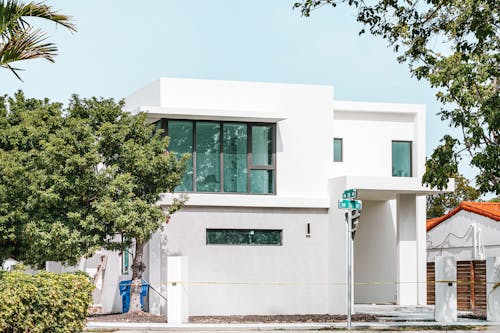 Free White Concrete Building Near Green Tree Stock Photo