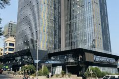 A contemporary view of the BPR Bank building showcasing modern glass architecture under clear skies.