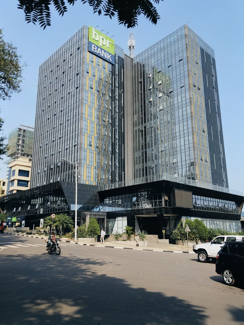 A contemporary view of the BPR Bank building showcasing modern glass architecture under clear skies.