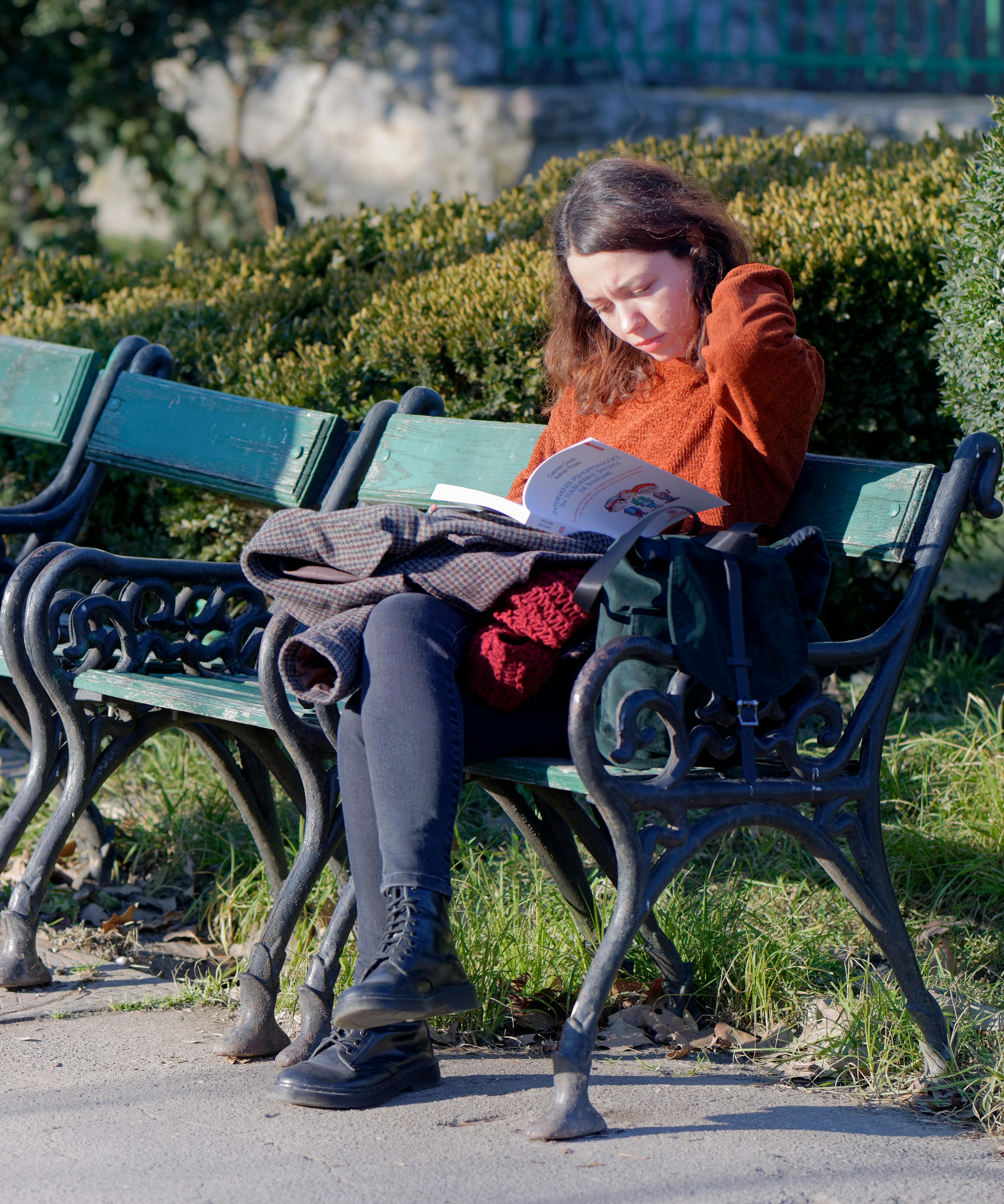 Woman In Red Long Sleeve Shirt And Gray Pants Sitting On Black