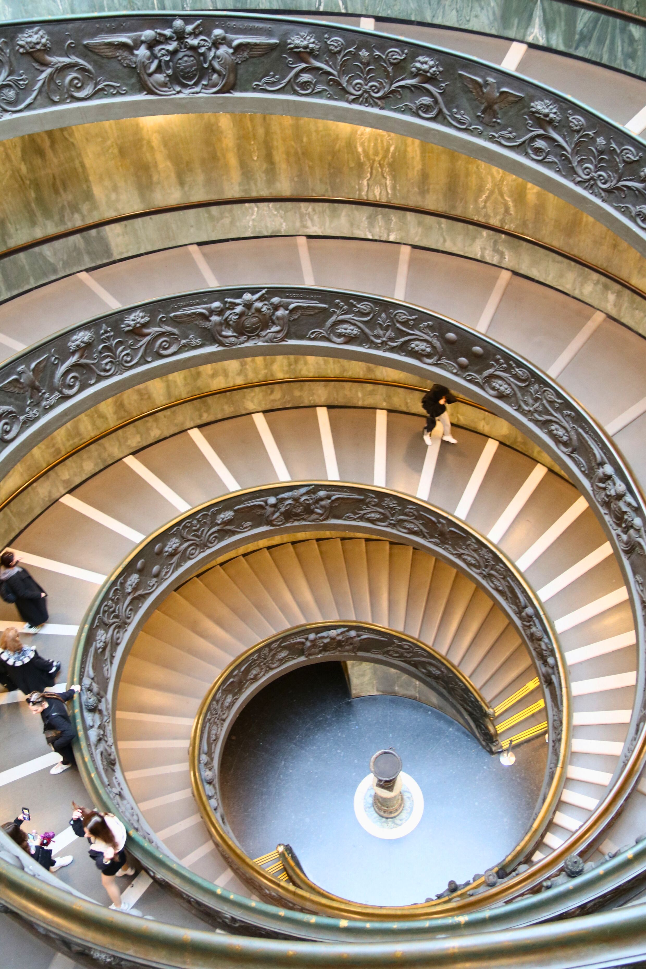 Elegant spiral staircase with intricate design in Vatican Museums, Vatican City.