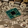 A detailed macro photograph of a microchip and electronic components on a printed circuit board.
