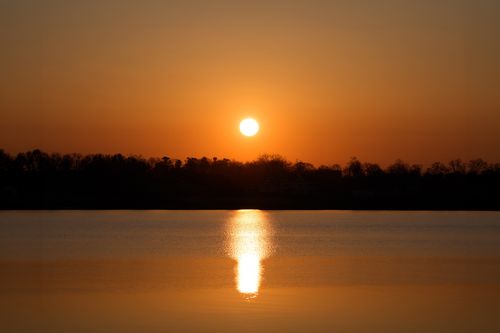 Free Peaceful sunrise view at Cove Island Park in Stamford, Connecticut with vibrant orange sky. Stock Photo