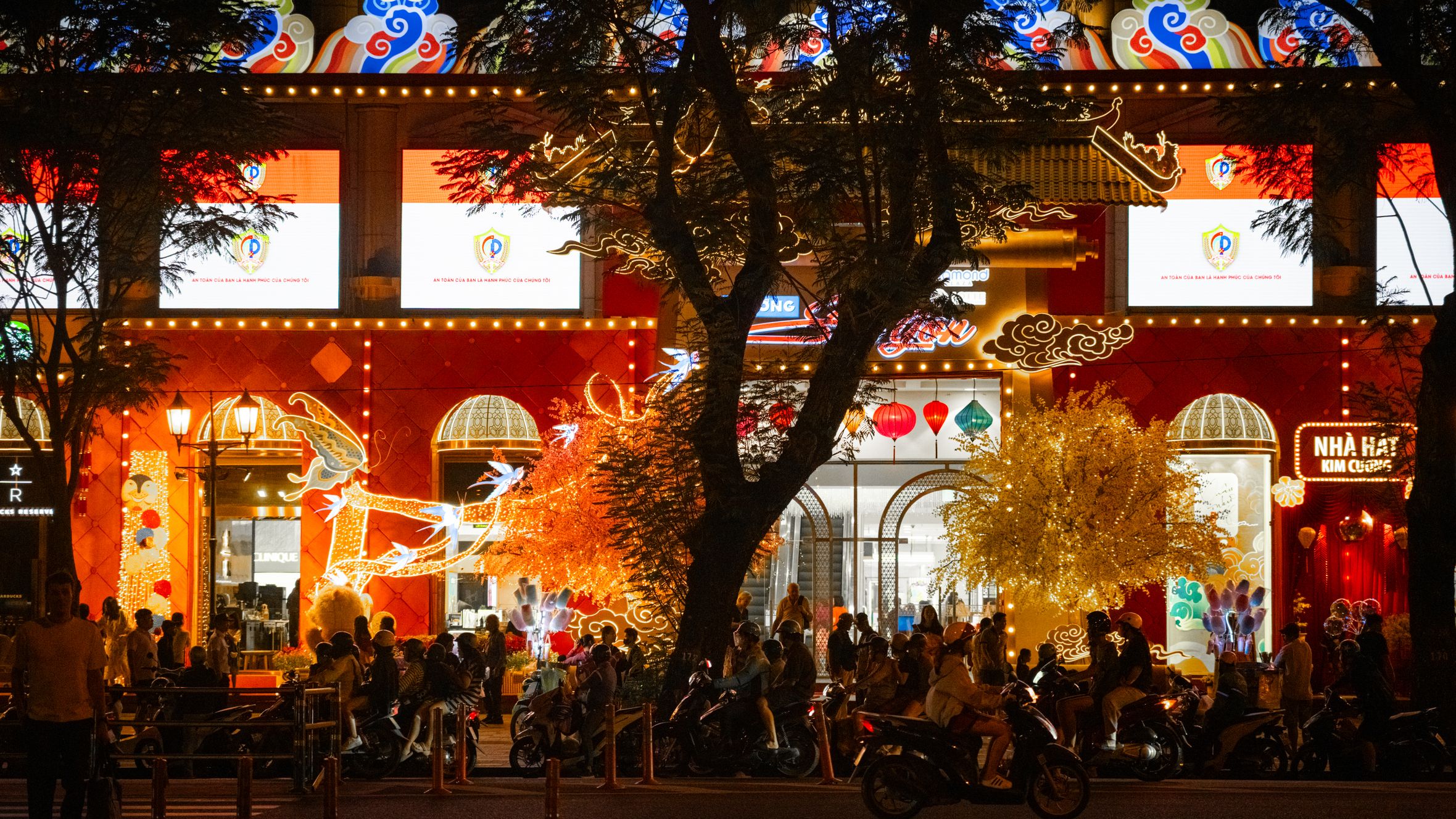 Bustling Ho Chi Minh City nightlife captured in a colorful street scene with neon lights and crowds.
