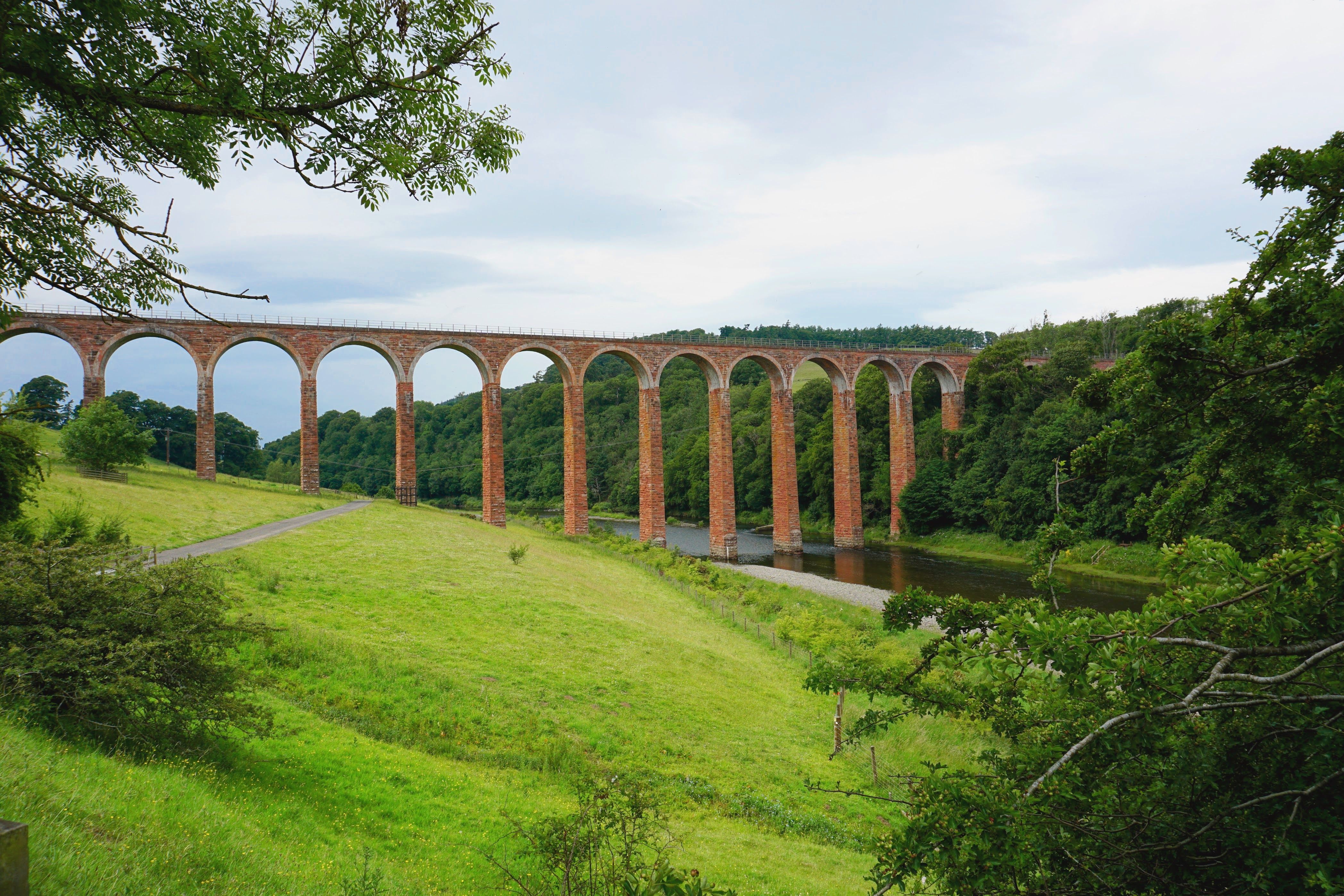 Railway viaduct arching over the River Nidd below Knaresborough's cliffside houses