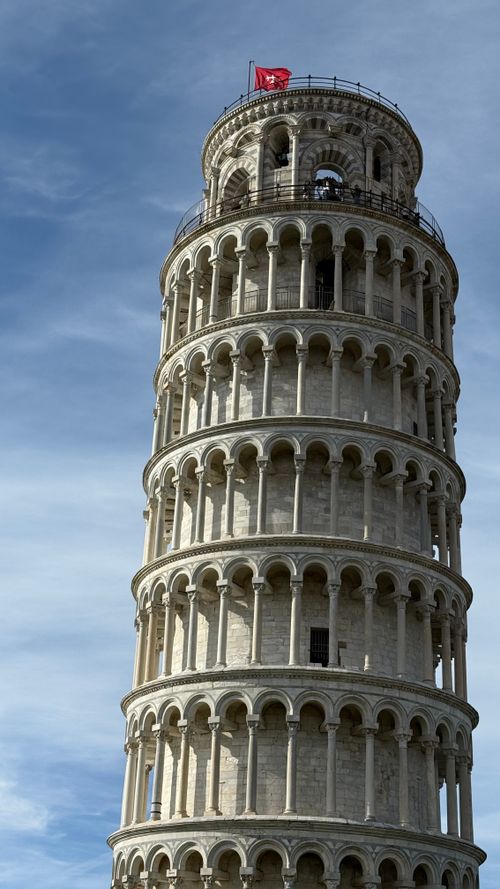Free Close-up view of the Leaning Tower of Pisa in Italy with a clear blue sky. Ideal for travel and architecture themes. Stock Photo