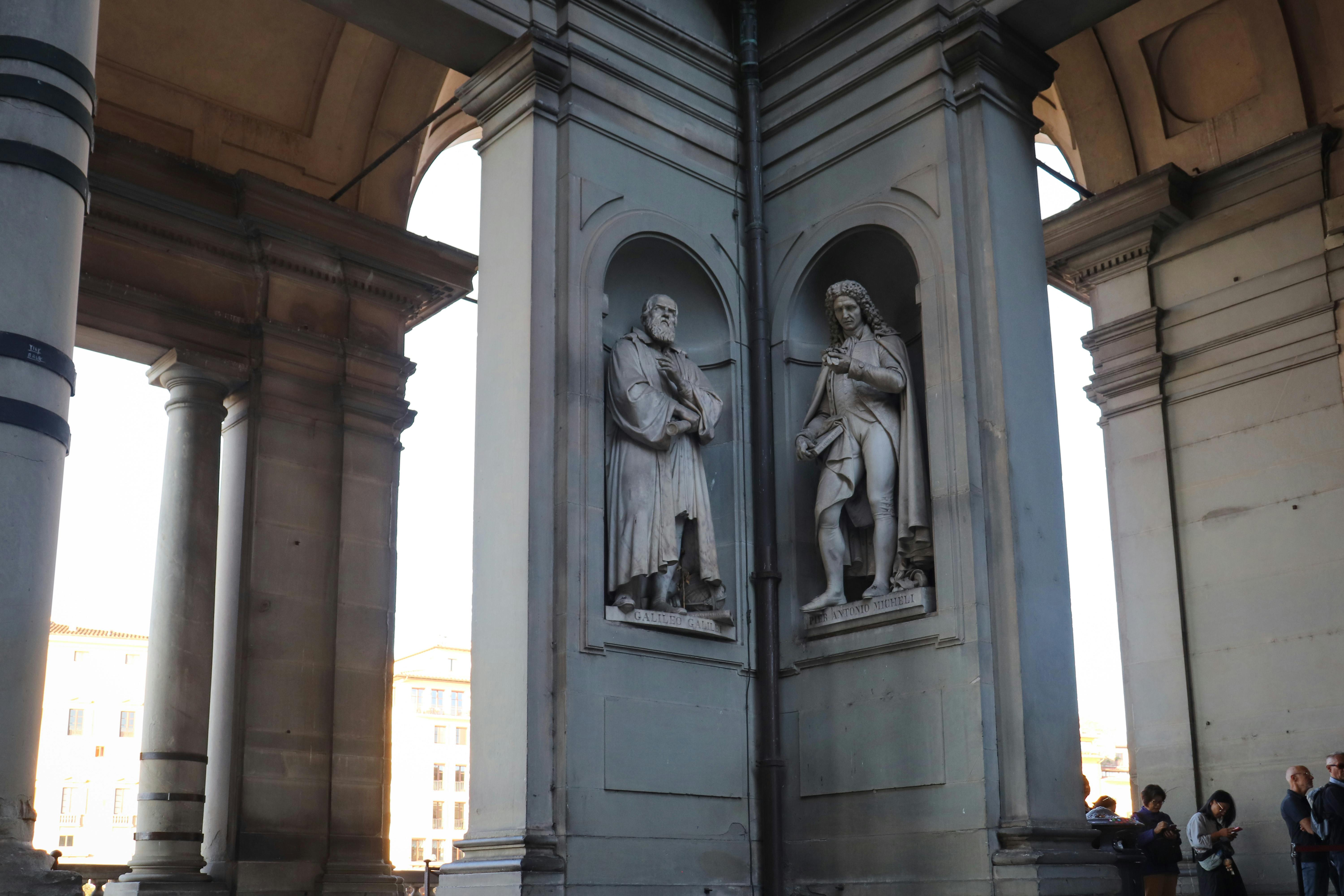 Renaissance statues outside Uffizi Gallery, Florence, Italy, showcasing architectural elegance.
