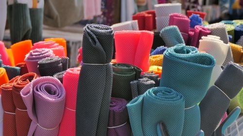 Free Vibrant rolls of mesh fabric displayed at a market in Mayen, Germany. Stock Photo