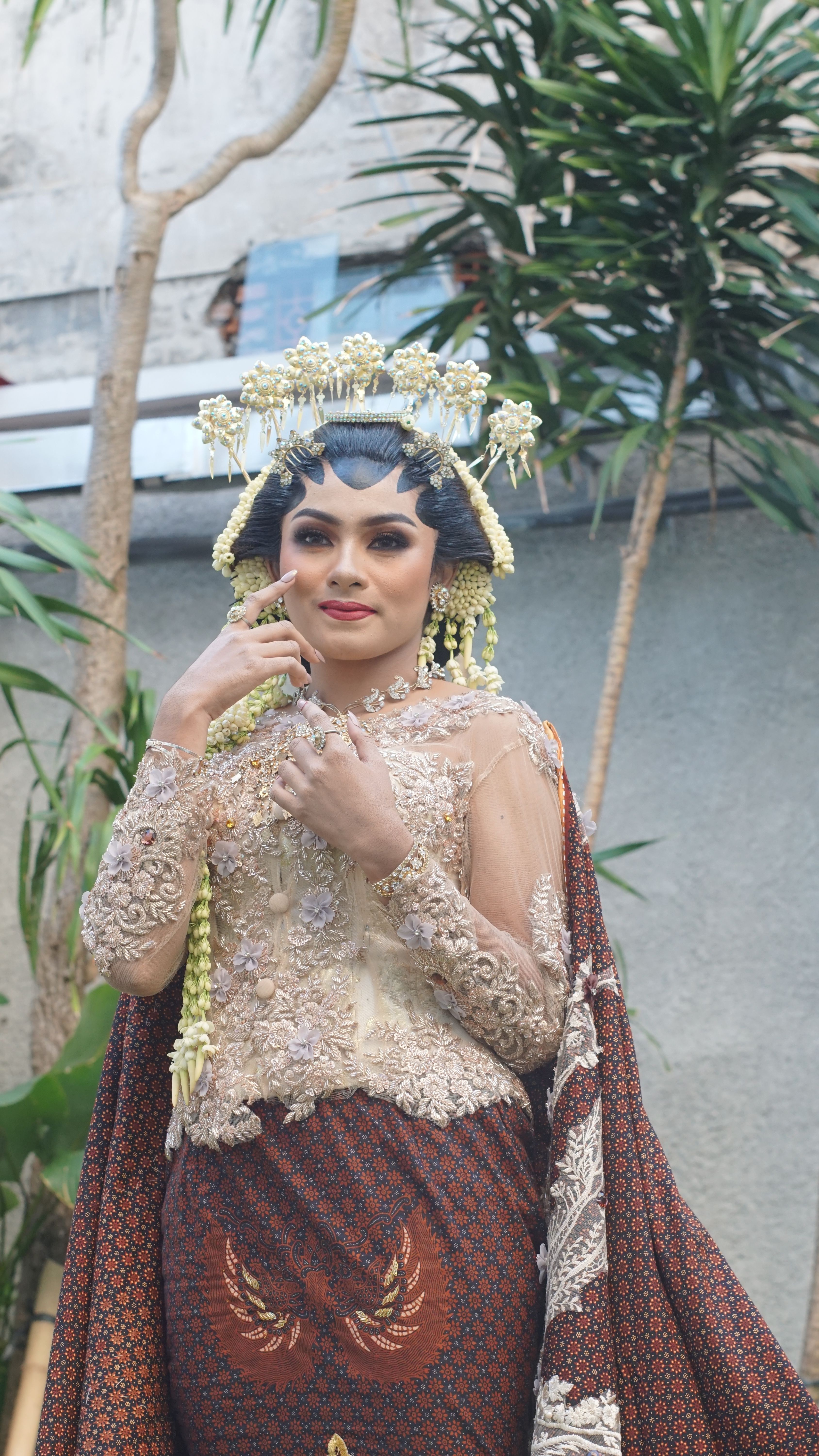 Stunning portrait of a woman in traditional Javanese wedding attire, showcasing intricate details and cultural elegance.