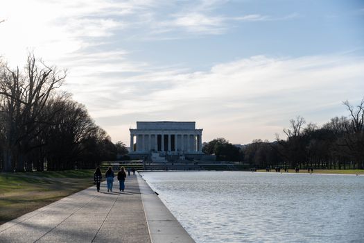 A serene day at Washington D.C.'s Lincoln Memorial with reflecting pool.