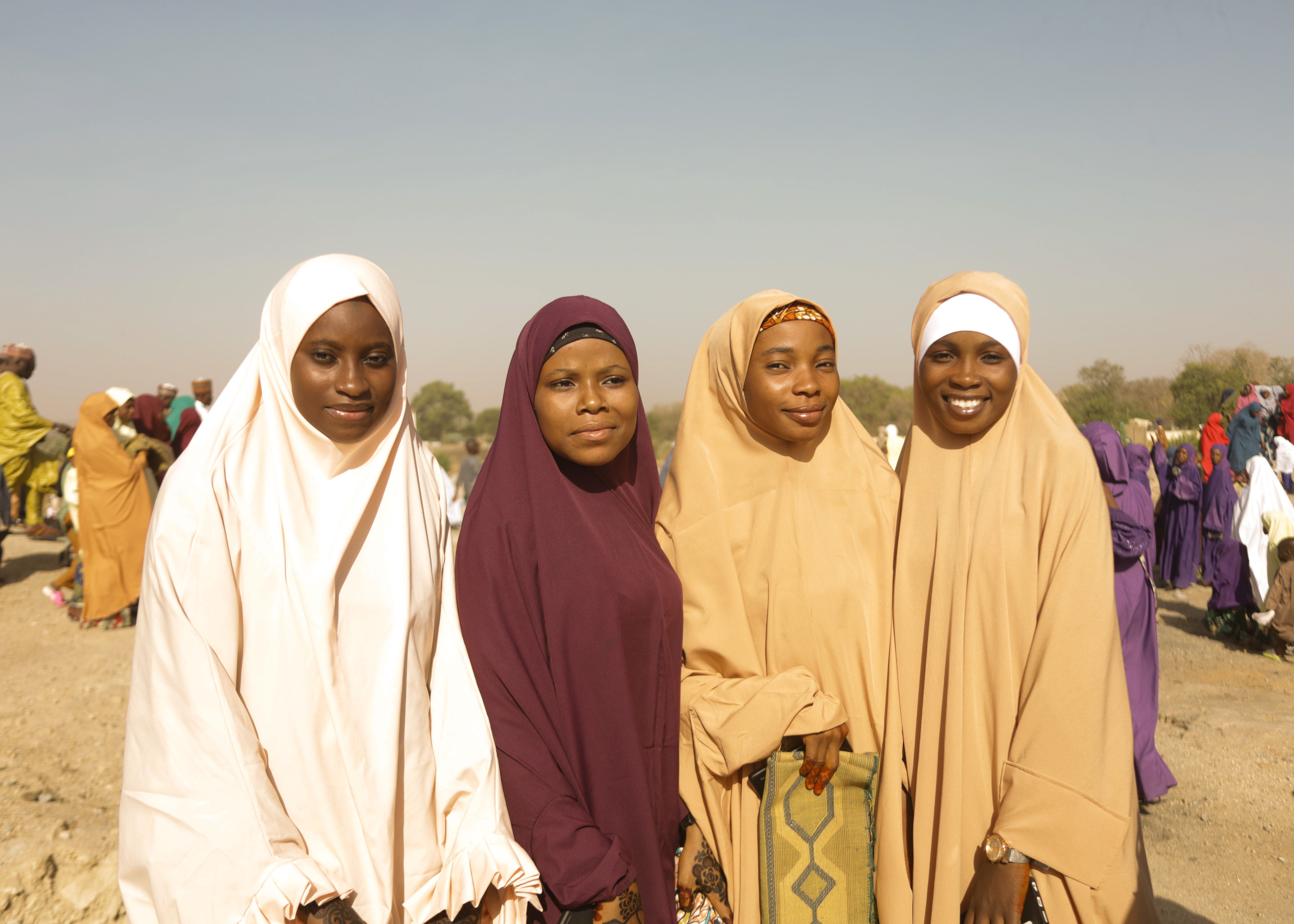 Group of Smiling Women in Traditional Attire Outdoors · Free Stock Photo