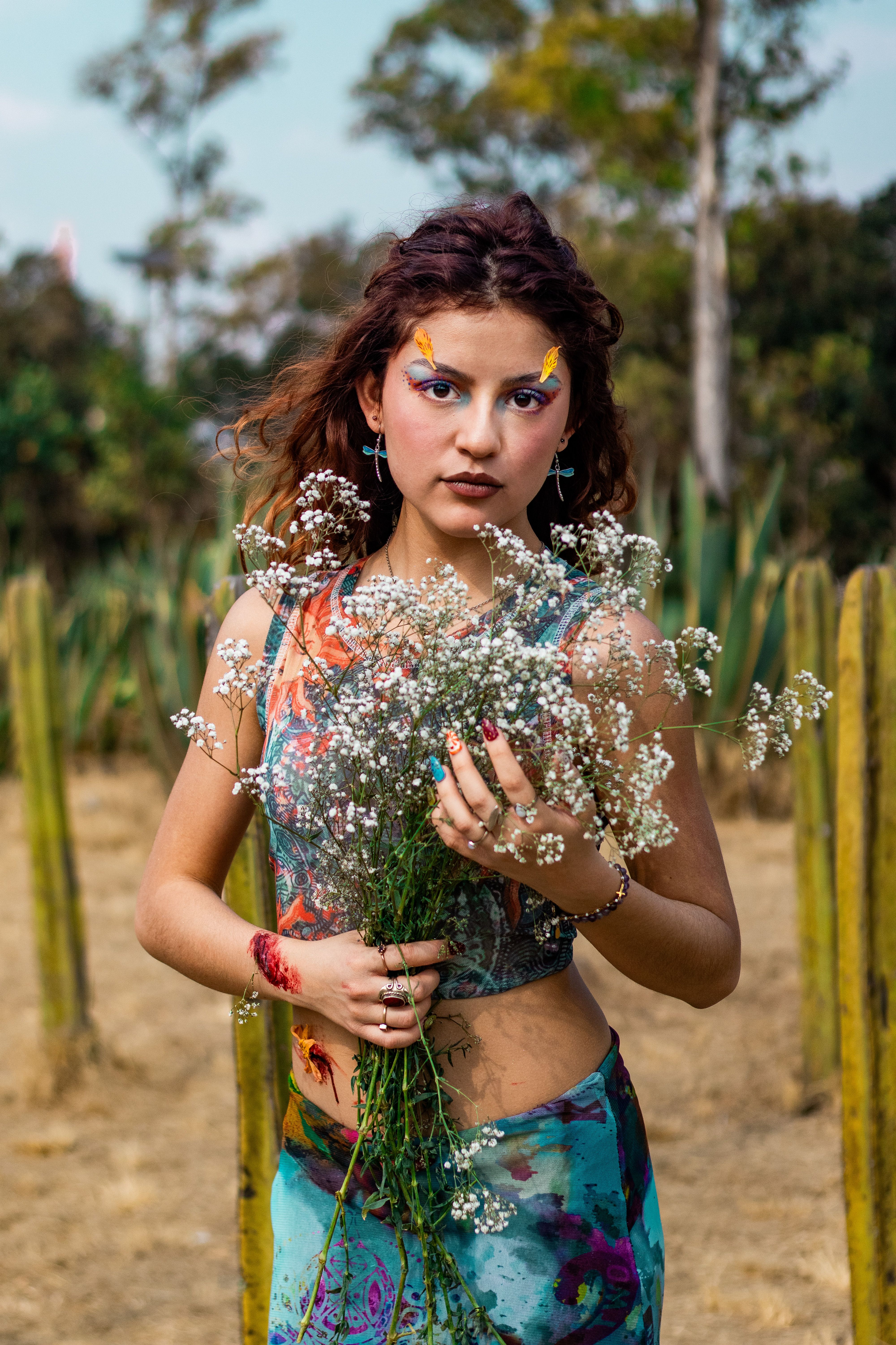 Young Woman Holding Flowers in a Field · Free Stock Photo