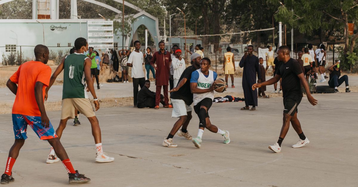 crowded outdoor sports court in Ho Ghana with players in jerseys