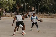 Exciting outdoor basketball game in Nigeria featuring athletic players in action.